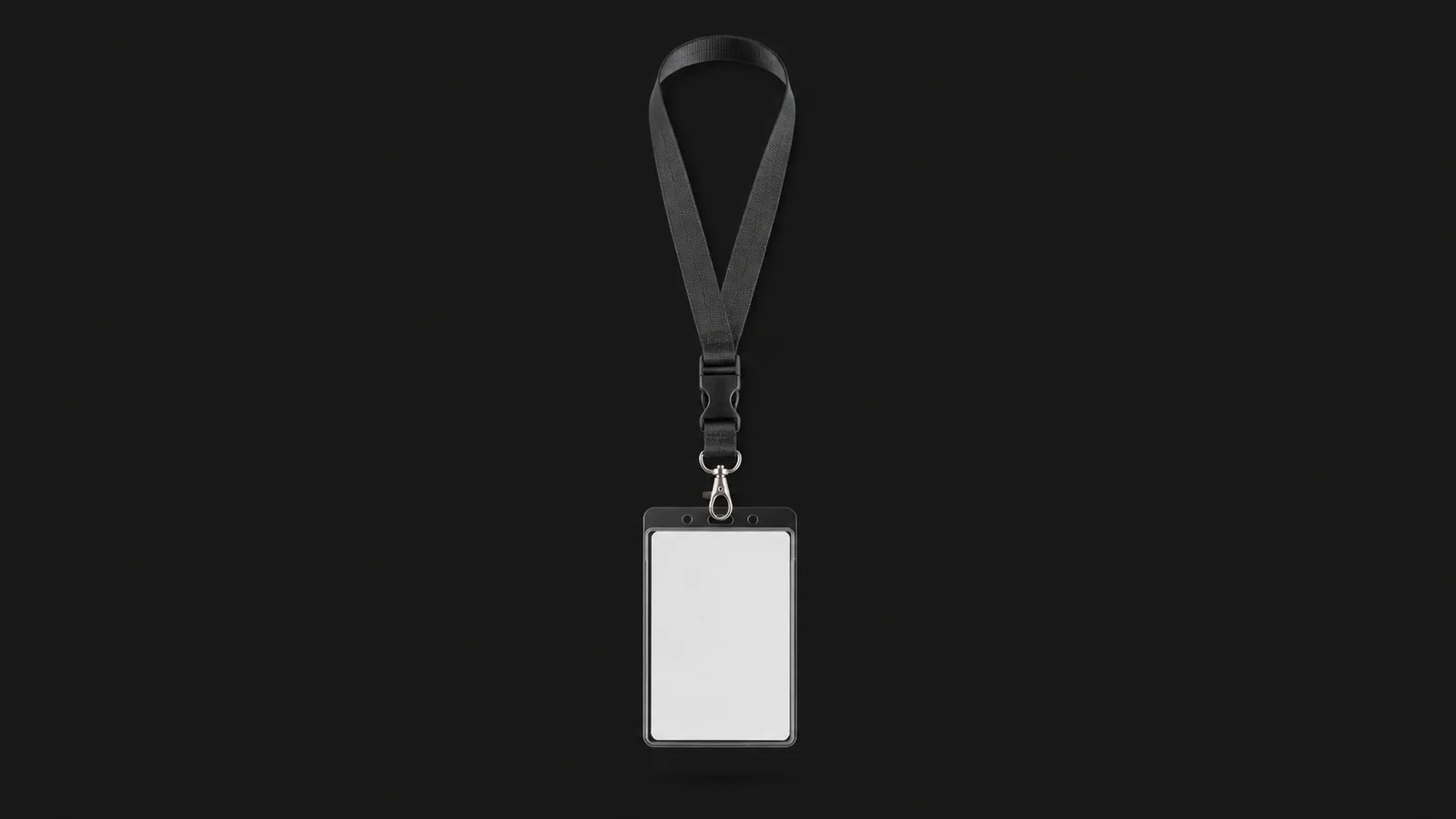 Isolated a lanyard-mounted rfid staff pass with a blank face centred on a seamless deep charcoal near-black studio background, generous empty margin on every side for overlaid branding