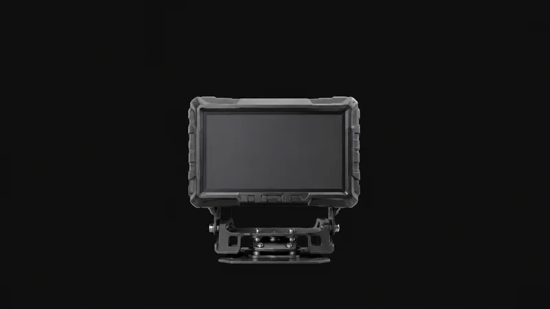 Isolated a rugged vehicle-mount terminal with a blank screen and heavy bracket centred on a seamless deep charcoal near-black studio background, generous empty margin on every side for overlaid branding