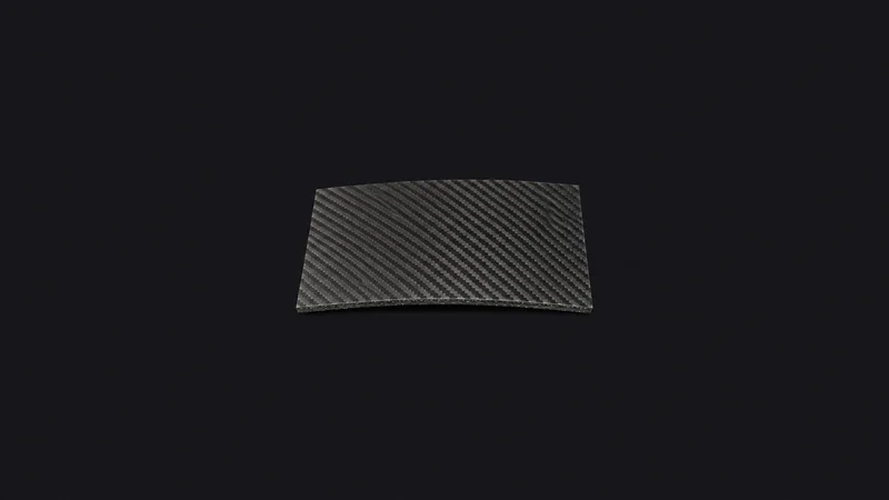 Isolated a carbon-fibre wing-skin coupon with a visible weave centred on a seamless deep charcoal near-black studio background, generous empty margin on every side for overlaid branding