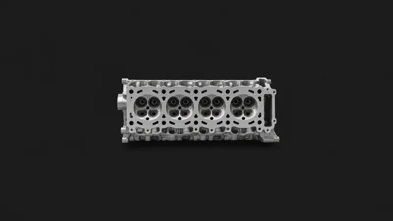 Isolated a bare car cylinder-head casting with valve seats centred on a seamless deep charcoal near-black studio background, generous empty margin on every side for overlaid branding