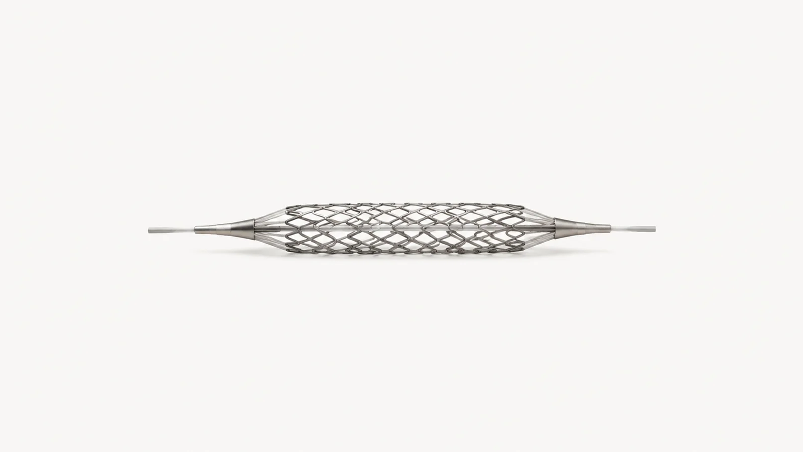 Isolated a nitinol vascular stent expanded on a mandrel centred on a seamless pale off-white studio background, generous empty margin on every side for overlaid branding