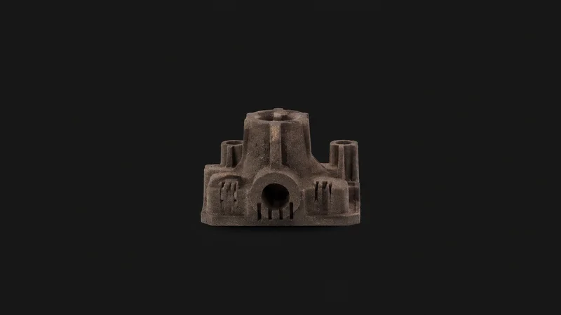 Isolated a hardened sand core with vent lines centred on a seamless deep charcoal near-black studio background, generous empty margin on every side for overlaid branding