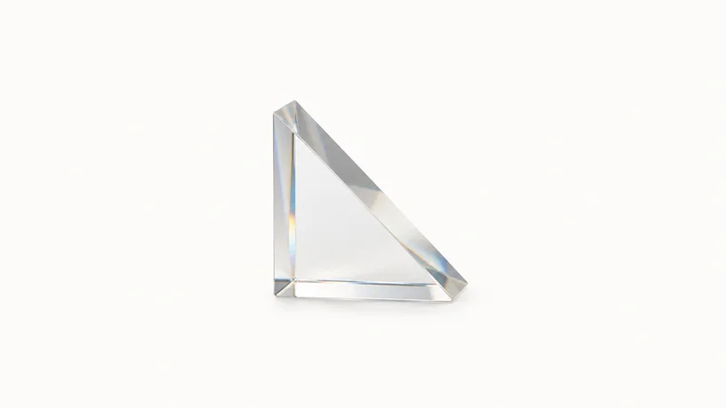 Isolated a right-angle prism of polished optical glass centred on a seamless pale off-white studio background, generous empty margin on every side for overlaid branding
