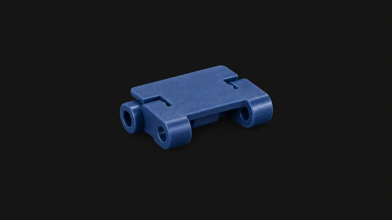 Isolated a plastic modular conveyor chain link in blue acetal centred on a seamless deep charcoal near-black studio background, generous empty margin on every side for overlaid branding