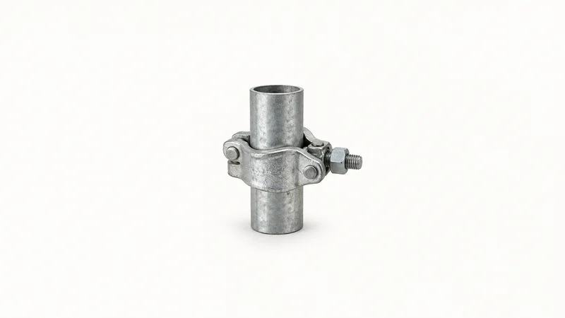Isolated a galvanised scaffold coupler clamped on a short scaffold-tube stub centred on a seamless pale off-white studio background, generous empty margin on every side for overlaid branding