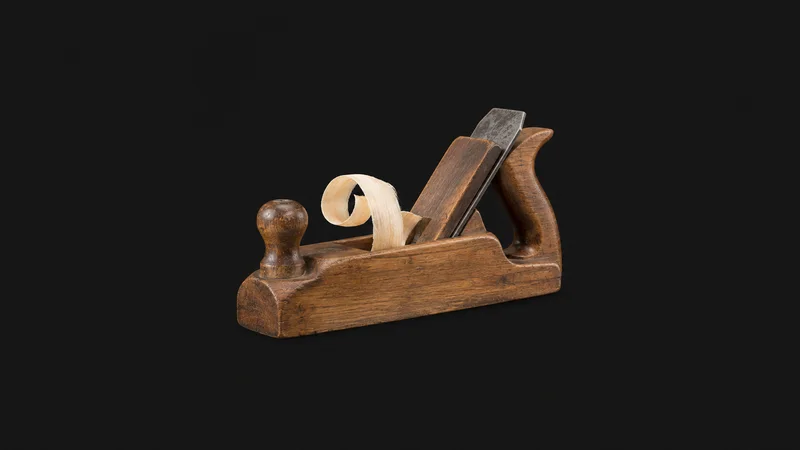 Isolated a wooden jack plane with a shaving curling from the mouth centred on a seamless deep charcoal near-black studio background, generous empty margin on every side for overlaid branding