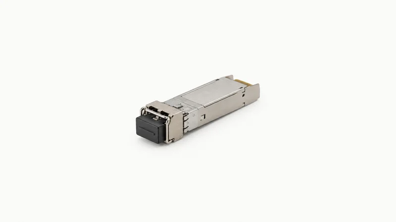 Isolated a fibre-optic transceiver module with a dust cap centred on a seamless pale off-white studio background, generous empty margin on every side for overlaid branding