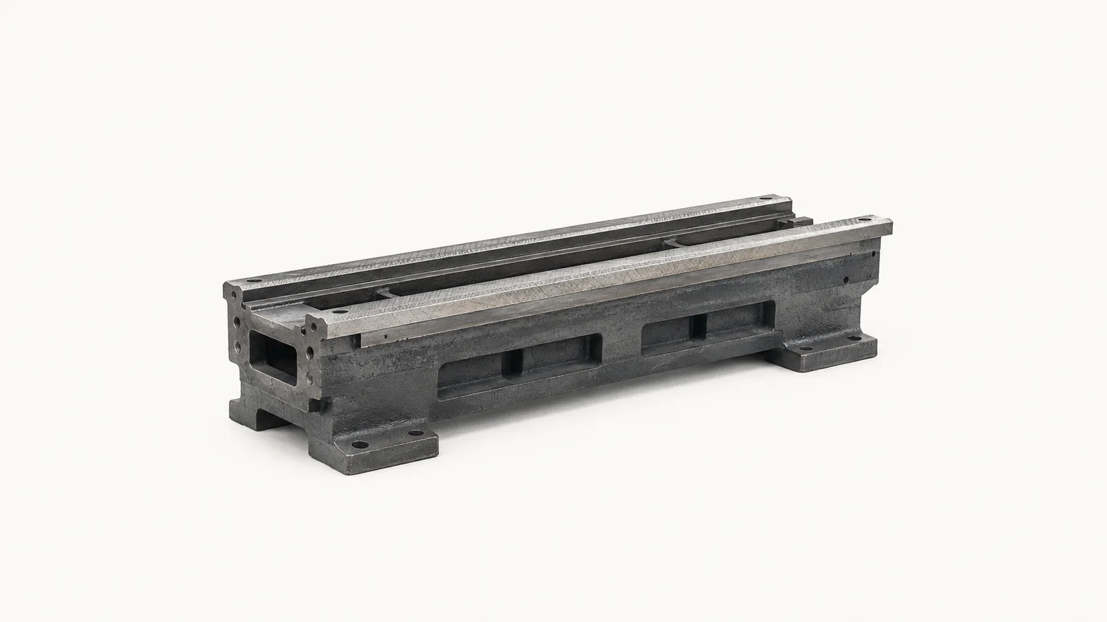 Isolated a cast machine-tool bed with hand-scraped ways centred on a seamless pale off-white studio background, generous empty margin on every side for overlaid branding