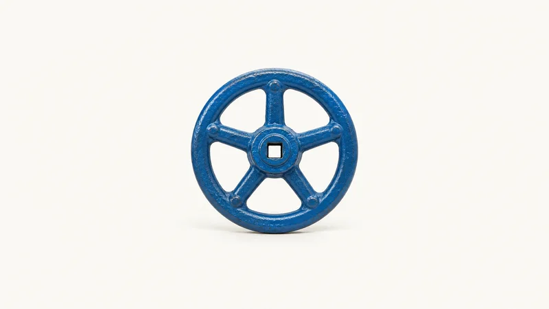 Isolated a cast-iron gate valve handwheel in blue paint centred on a seamless pale off-white studio background, generous empty margin on every side for overlaid branding