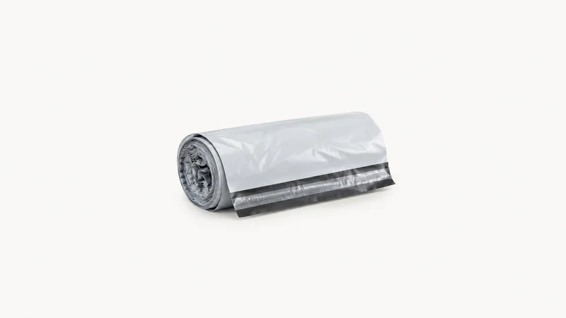 Isolated a rolled polythene courier mailing bag with a self-seal strip centred on a seamless pale off-white studio background, generous empty margin on every side for overlaid branding