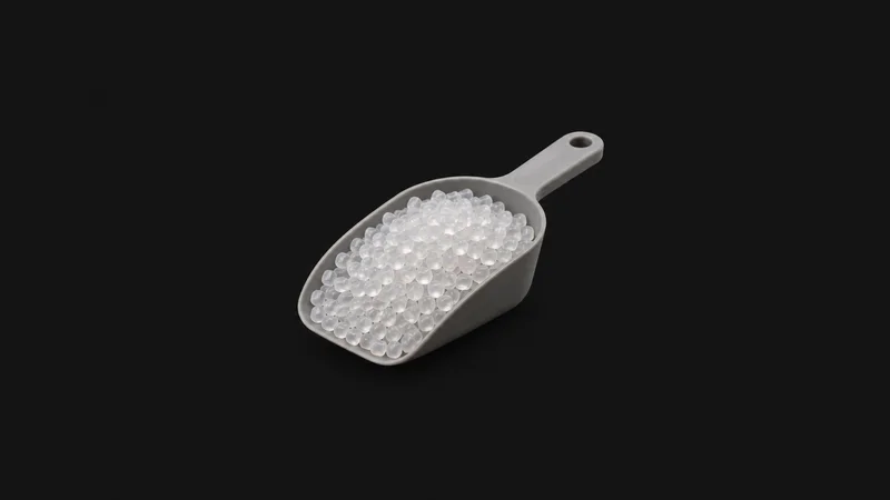Isolated a scoop of translucent polypropylene pellets centred on a seamless deep charcoal near-black studio background, generous empty margin on every side for overlaid branding