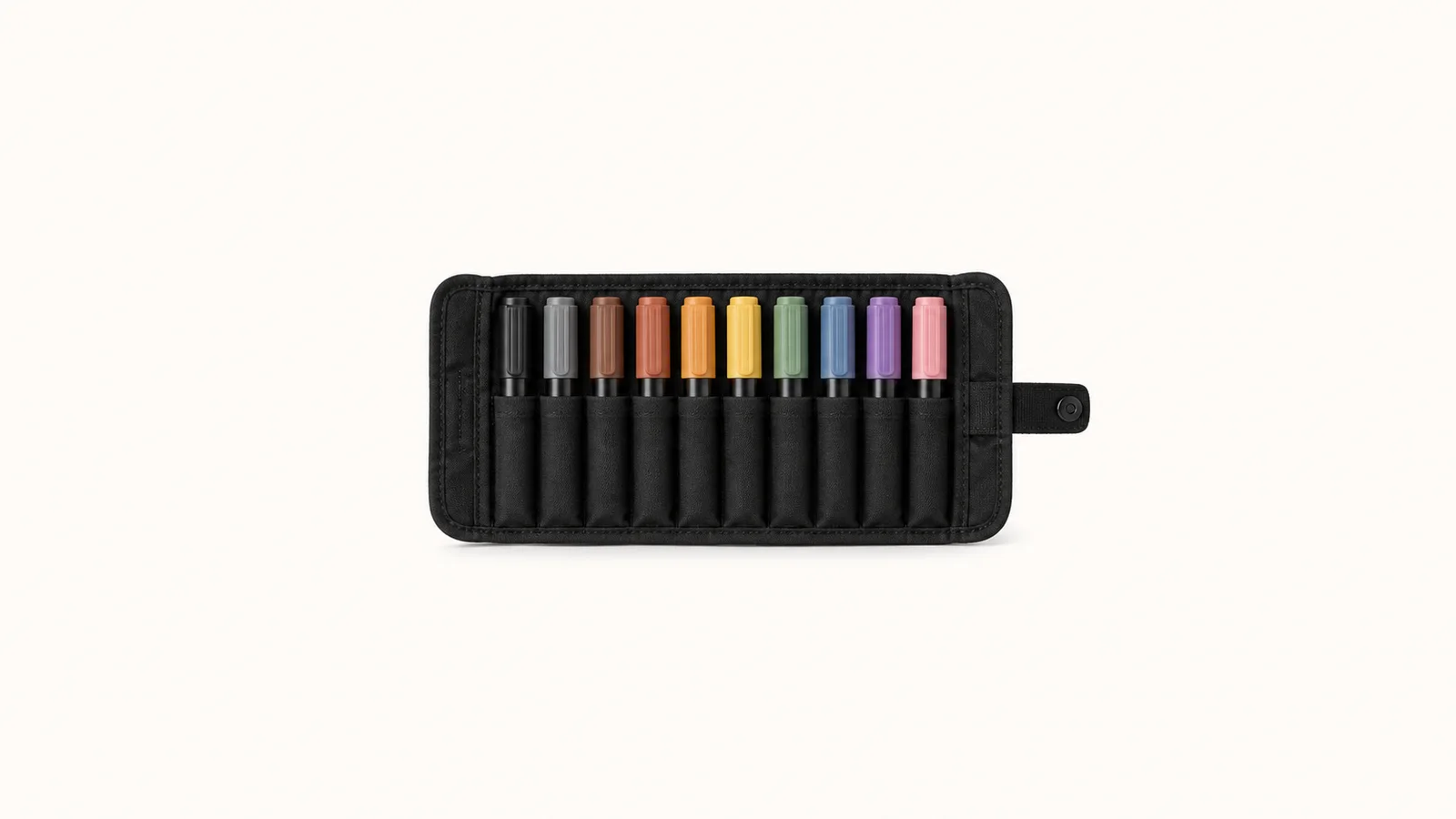 Isolated a set of chunky felt-tip marker pens in a black roll centred on a seamless pale off-white studio background, generous empty margin on every side for overlaid branding