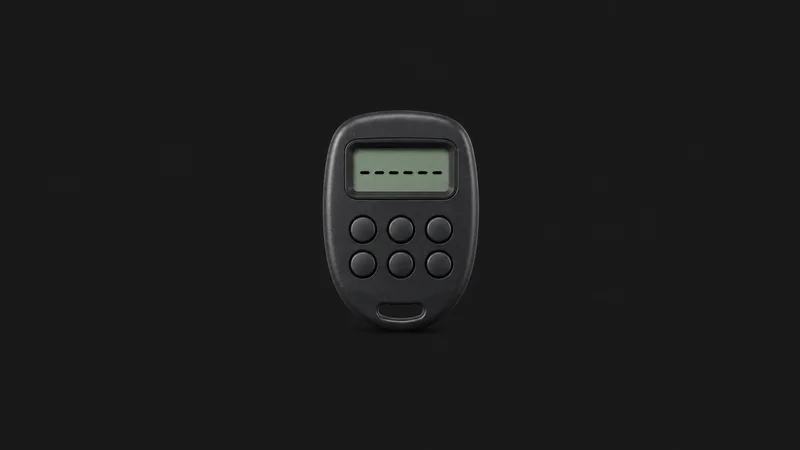 Isolated a pocket-sized one-time-passcode token with a segment display centred on a seamless deep charcoal near-black studio background, generous empty margin on every side for overlaid branding