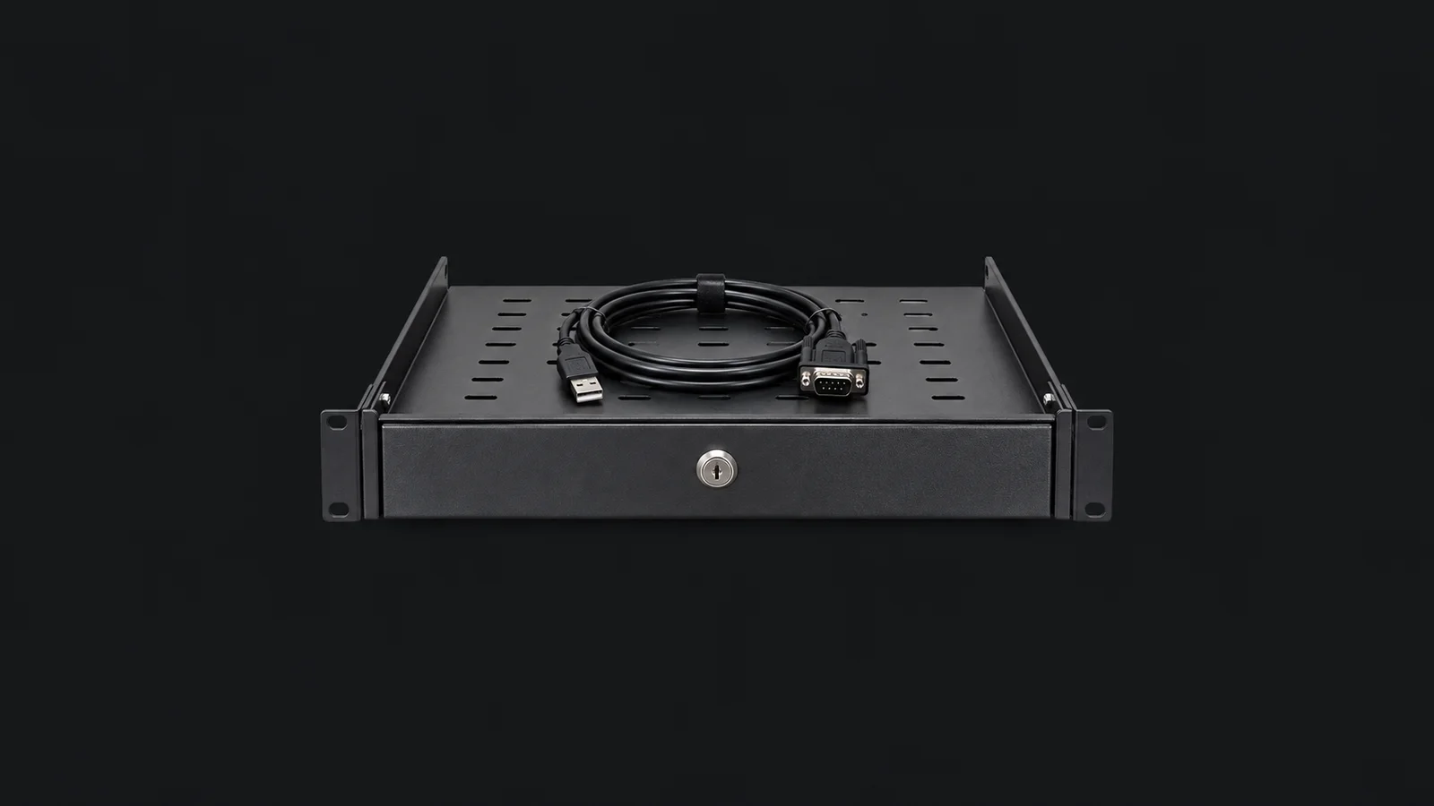 Isolated a keyed rack shelf with a coiled console cable centred on a seamless deep charcoal near-black studio background, generous empty margin on every side for overlaid branding