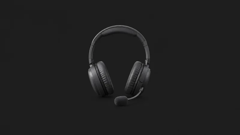 Isolated an over-ear headset with a boom microphone for language lessons centred on a seamless deep charcoal near-black studio background, generous empty margin on every side for overlaid branding