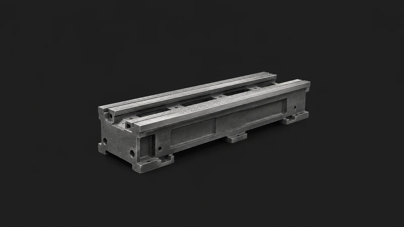 Isolated a cast machine-tool bed with hand-scraped ways centred on a seamless deep charcoal near-black studio background, generous empty margin on every side for overlaid branding