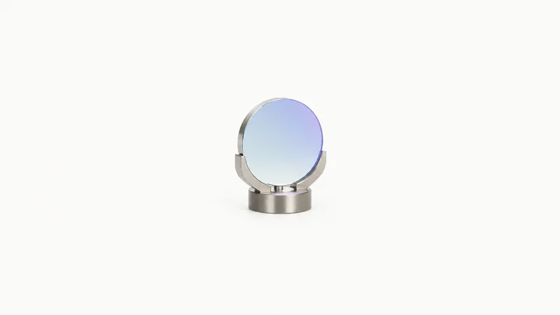 Isolated a first-surface mirror with a dielectric coating centred on a seamless pale off-white studio background, generous empty margin on every side for overlaid branding