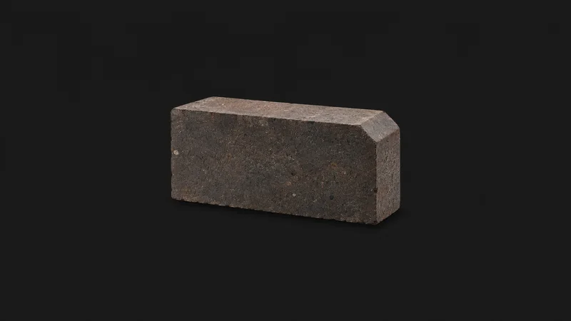 Isolated a refractory brick with a chamfered edge centred on a seamless deep charcoal near-black studio background, generous empty margin on every side for overlaid branding