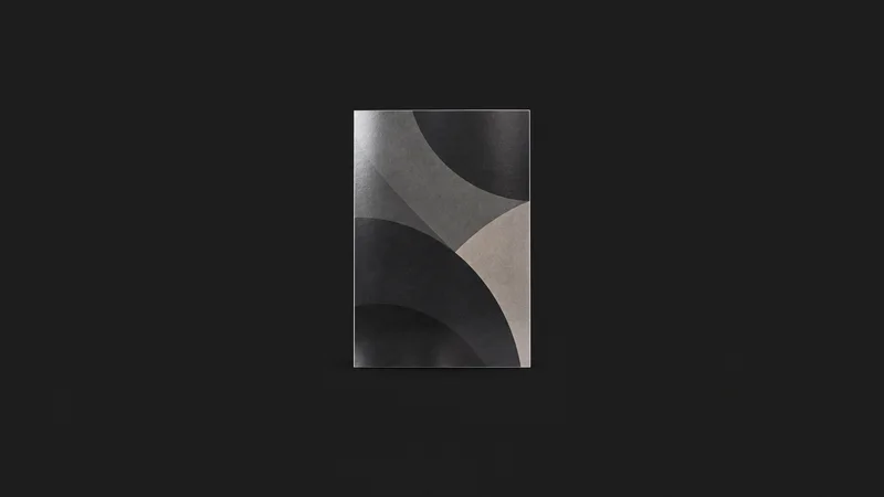 Isolated a laminated poster proof on heavyweight satin stock centred on a seamless deep charcoal near-black studio background, generous empty margin on every side for overlaid branding