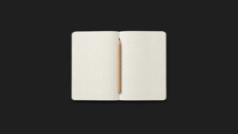 Isolated a grid-ruled dot notebook opened flat with a pencil centred on a seamless deep charcoal near-black studio background, generous empty margin on every side for overlaid branding