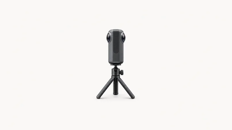 Isolated a compact 360-degree property-scanning camera on a small tripod centred on a seamless pale off-white studio background, generous empty margin on every side for overlaid branding