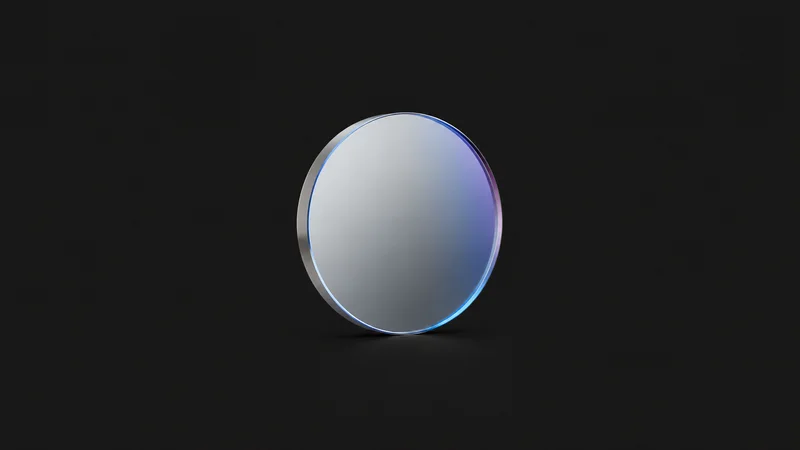 Isolated a first-surface mirror with a dielectric coating centred on a seamless deep charcoal near-black studio background, generous empty margin on every side for overlaid branding