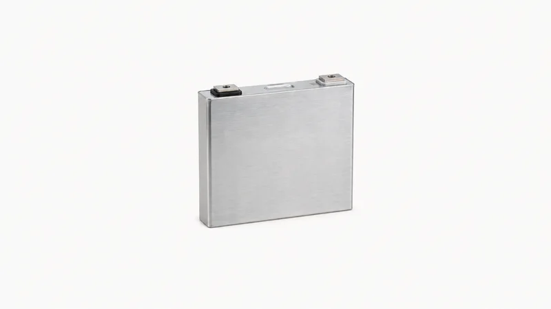 Isolated a prismatic battery cell in an aluminium case centred on a seamless pale off-white studio background, generous empty margin on every side for overlaid branding