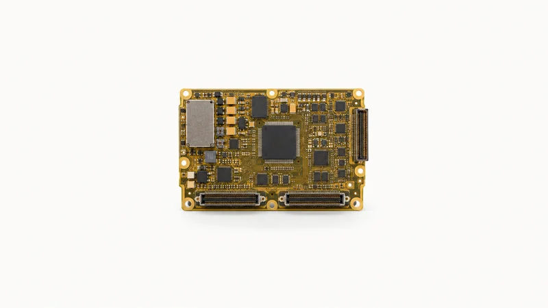 Isolated a conformal-coated circuit board with a gold-tinted finish centred on a seamless pale off-white studio background, generous empty margin on every side for overlaid branding