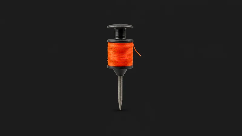 Isolated a builder's line pin with a wound reel of orange stringline centred on a seamless deep charcoal near-black studio background, generous empty margin on every side for overlaid branding