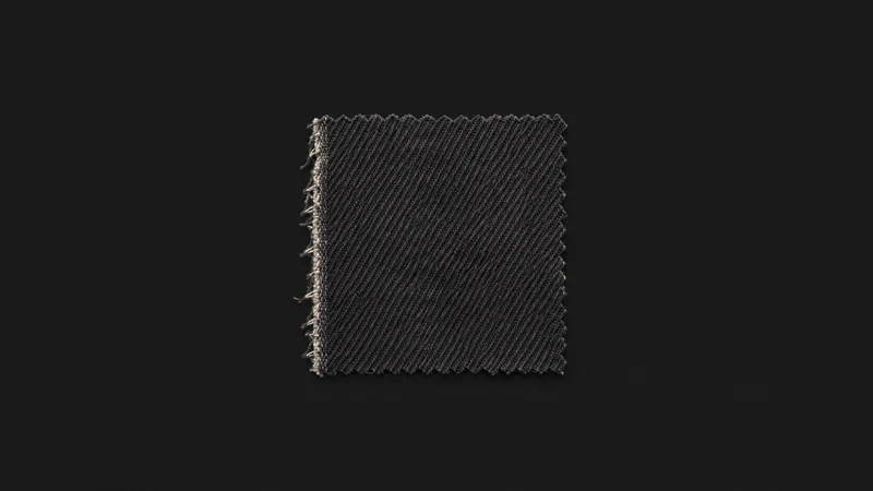 Isolated a swatch of twill fabric with a raw selvedge centred on a seamless deep charcoal near-black studio background, generous empty margin on every side for overlaid branding