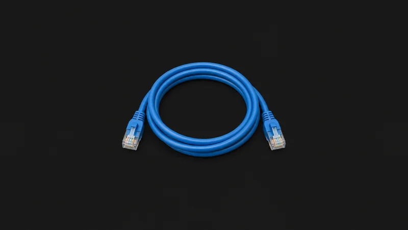 Isolated a single blue ethernet cable coiled in a loop centred on a seamless deep charcoal near-black studio background, generous empty margin on every side for overlaid branding