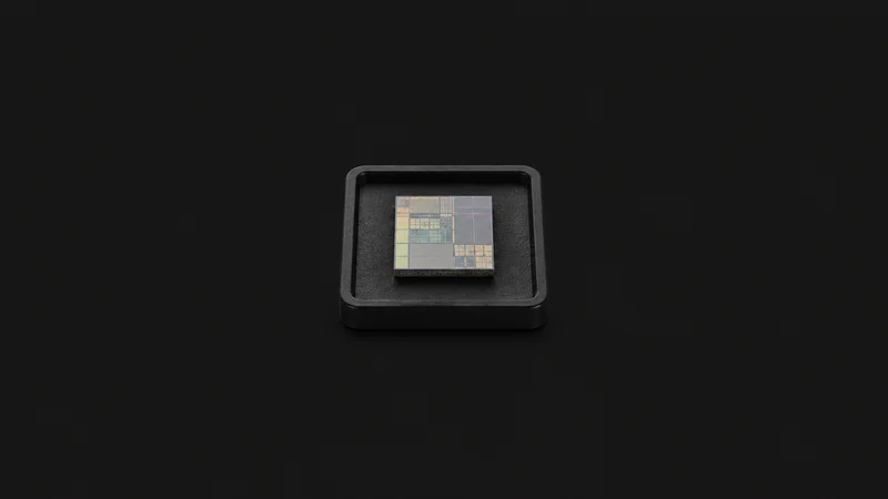Isolated a single diced silicon die on a black tray centred on a seamless deep charcoal near-black studio background, generous empty margin on every side for overlaid branding