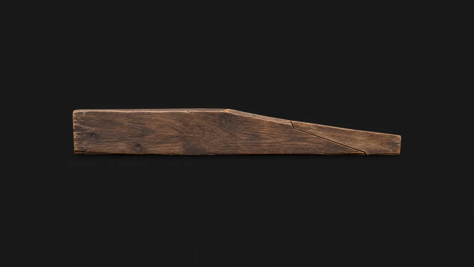 Isolated a length of carvel planking with a scarf joint cut on one end centred on a seamless deep charcoal near-black studio background, generous empty margin on every side for overlaid branding