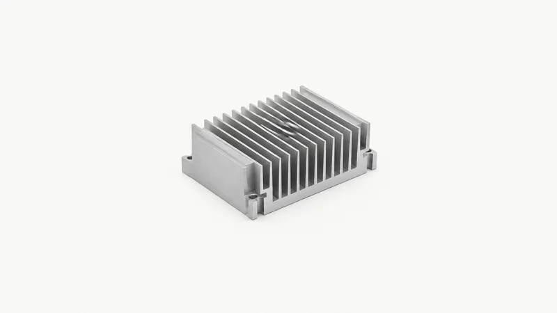 Isolated an anodised aluminium machined heat-sink block with fin geometry centred on a seamless pale off-white studio background, generous empty margin on every side for overlaid branding
