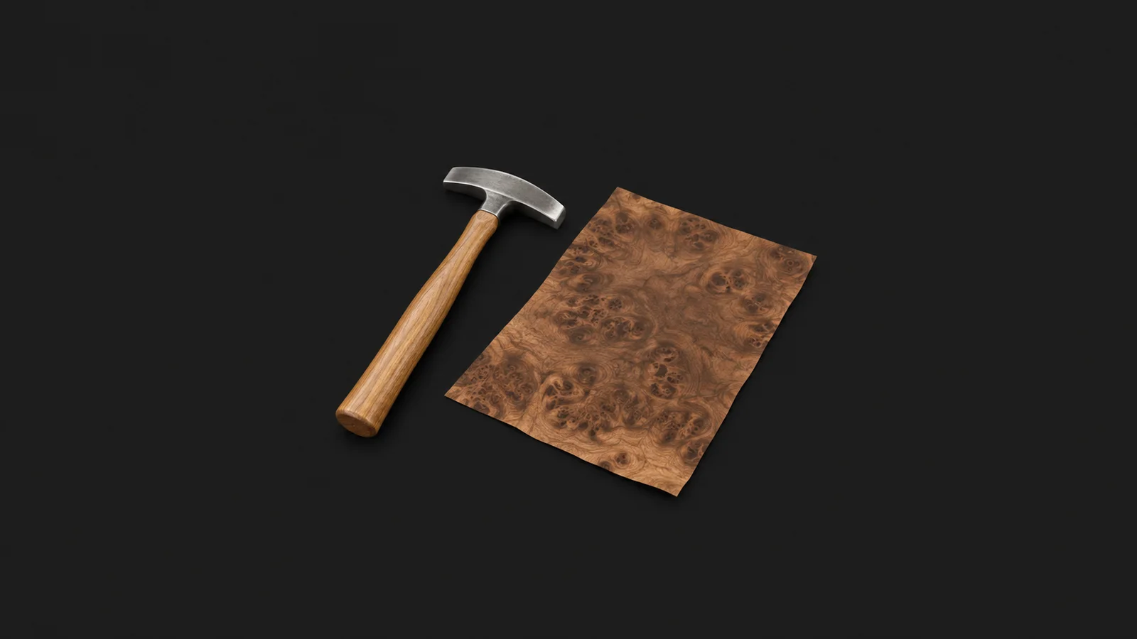 Isolated a veneer hammer beside a sheet of burr-walnut veneer centred on a seamless deep charcoal near-black studio background, generous empty margin on every side for overlaid branding