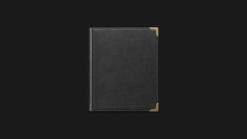 Isolated a blank deed folder with a brass corner clasp centred on a seamless deep charcoal near-black studio background, generous empty margin on every side for overlaid branding