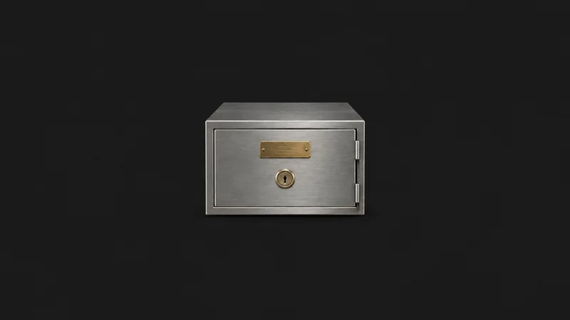 Isolated a stainless steel safe-deposit box with a numbered brass plate centred on a seamless deep charcoal near-black studio background, generous empty margin on every side for overlaid branding