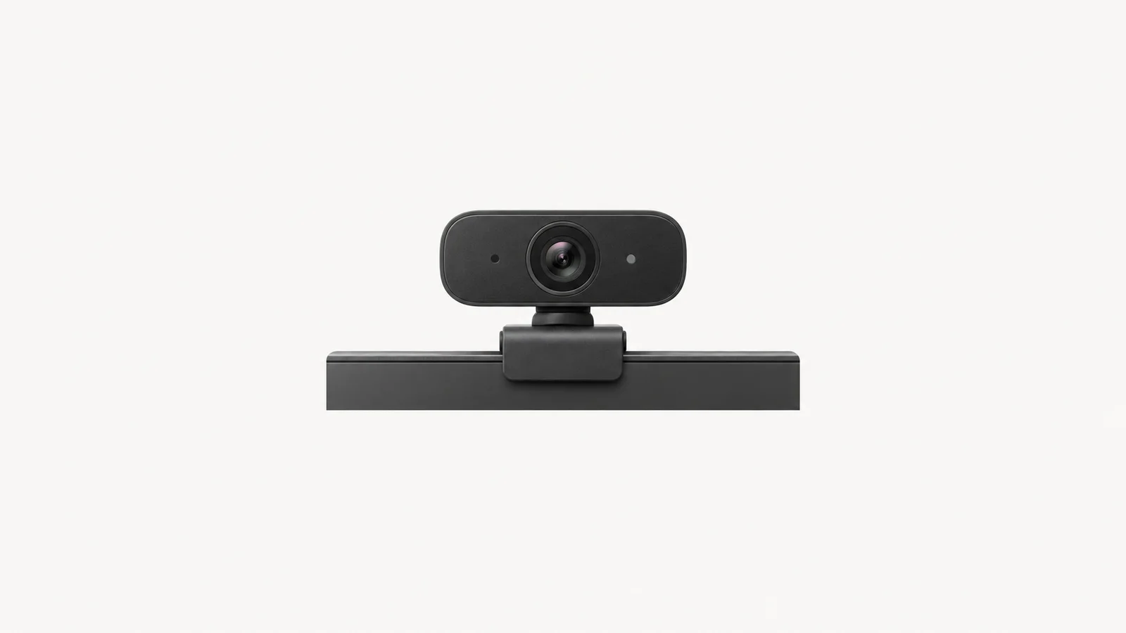 Isolated a webcam clipped to a monitor edge for video interviewing centred on a seamless pale off-white studio background, generous empty margin on every side for overlaid branding