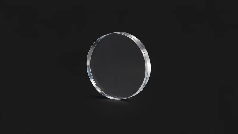 Isolated a fused-silica optical flat with a bevelled edge centred on a seamless deep charcoal near-black studio background, generous empty margin on every side for overlaid branding