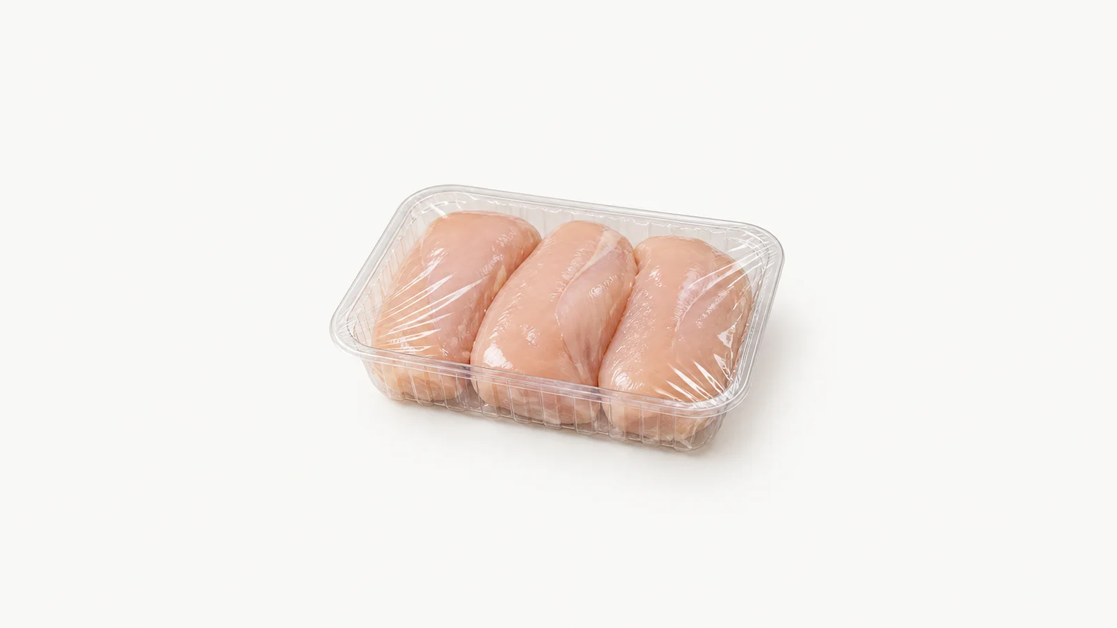 Isolated a clear shrink-wrapped tray of portioned product centred on a seamless pale off-white studio background, generous empty margin on every side for overlaid branding