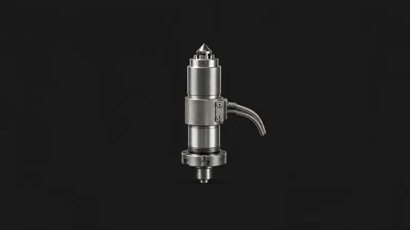 Isolated a hot-runner nozzle assembly with heater band centred on a seamless deep charcoal near-black studio background, generous empty margin on every side for overlaid branding