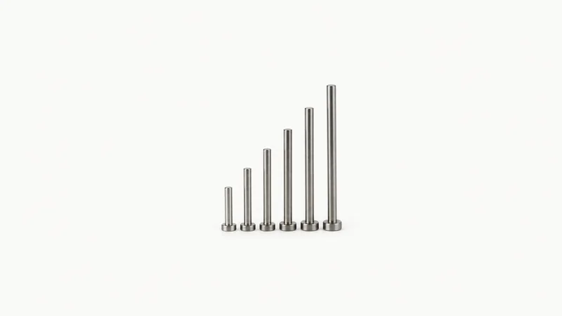 Isolated a set of ejector pins in graduated lengths centred on a seamless pale off-white studio background, generous empty margin on every side for overlaid branding