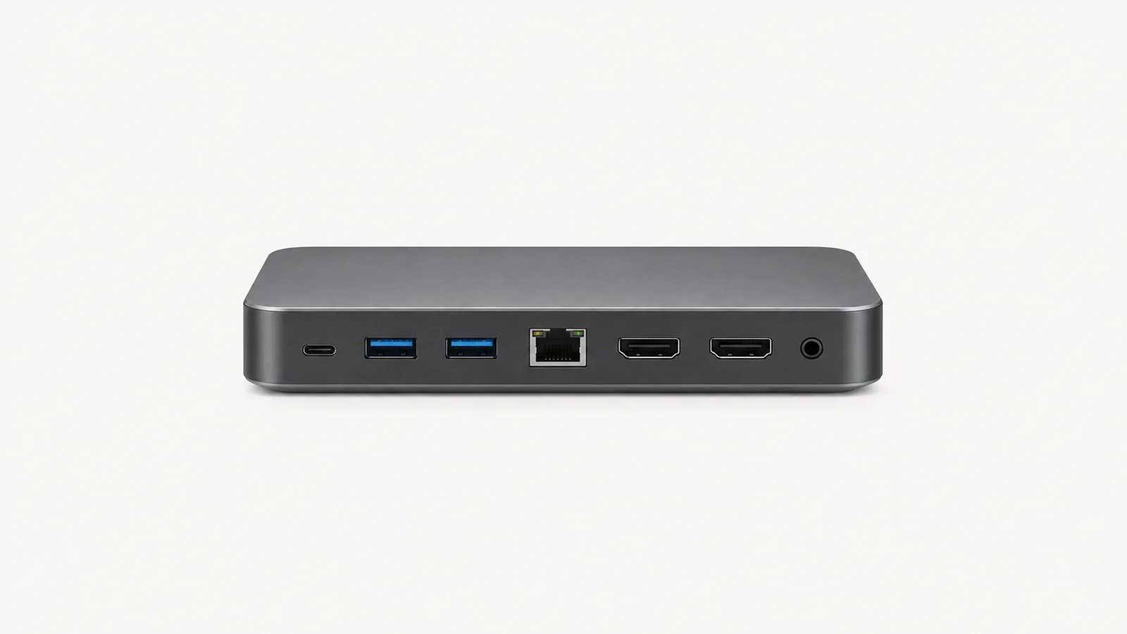 Isolated a laptop docking station with its ports facing out centred on a seamless pale off-white studio background, generous empty margin on every side for overlaid branding