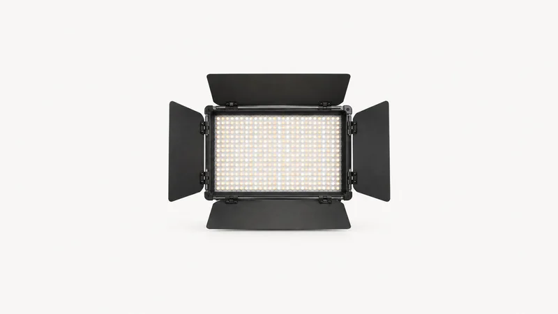 Isolated a bi-colour LED panel light with barn doors centred on a seamless pale off-white studio background, generous empty margin on every side for overlaid branding