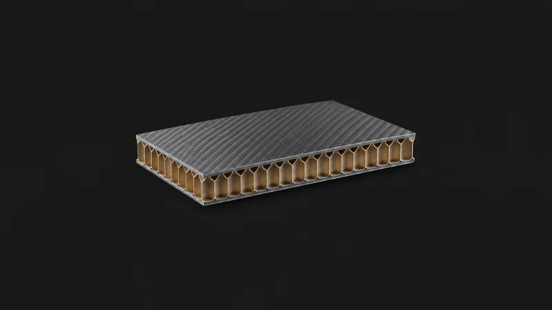 Isolated a cured honeycomb-core sandwich panel section centred on a seamless deep charcoal near-black studio background, generous empty margin on every side for overlaid branding