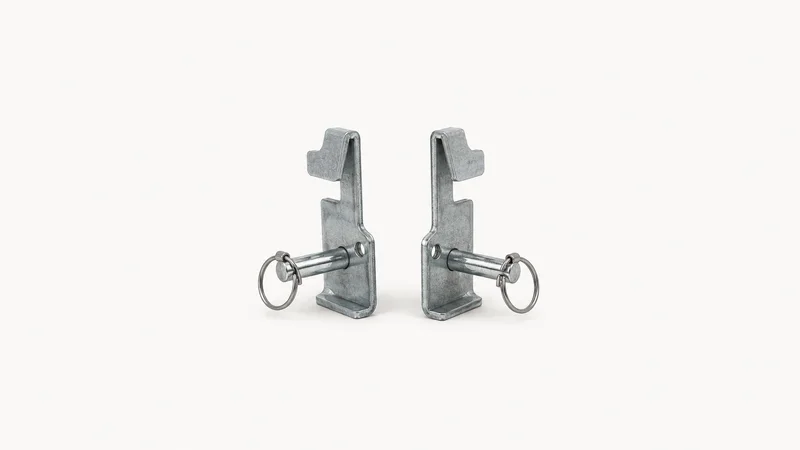 Isolated a pair of steel racking beam locks with safety pins centred on a seamless pale off-white studio background, generous empty margin on every side for overlaid branding