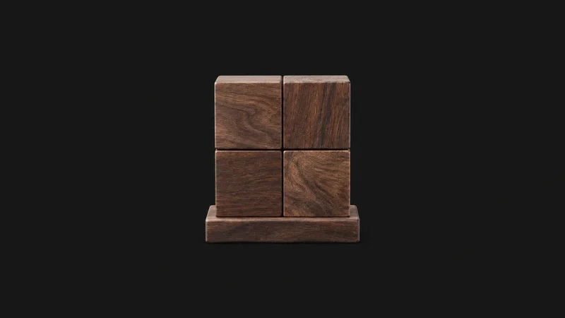 Isolated a wooden two-by-two matrix block on a base centred on a seamless deep charcoal near-black studio background, generous empty margin on every side for overlaid branding
