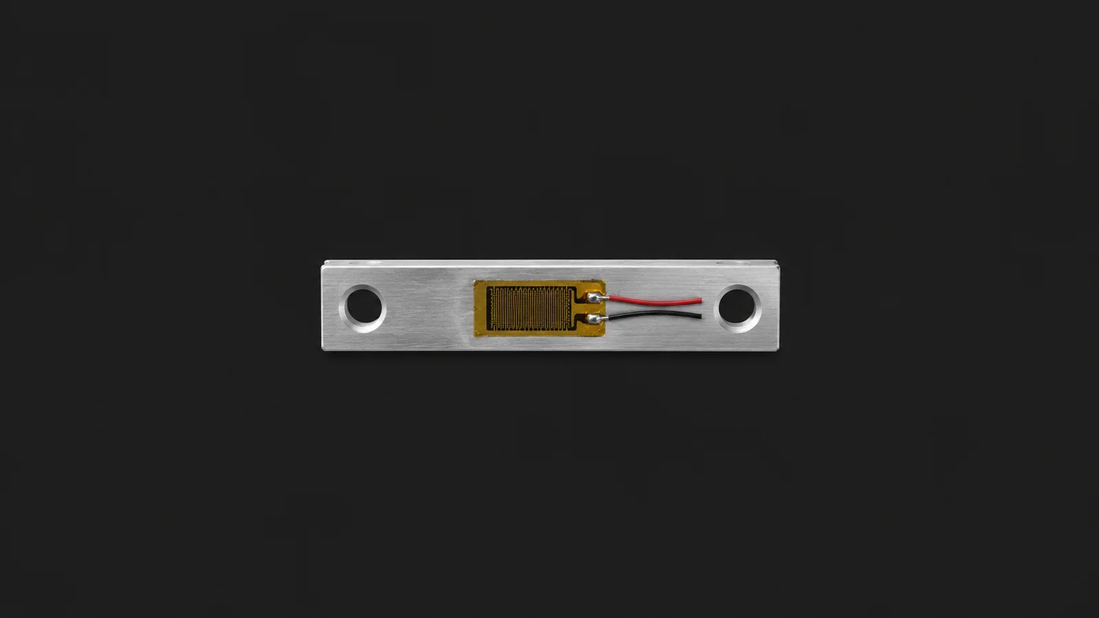 Isolated a strain gauge mounted on a small aluminium strip centred on a seamless deep charcoal near-black studio background, generous empty margin on every side for overlaid branding