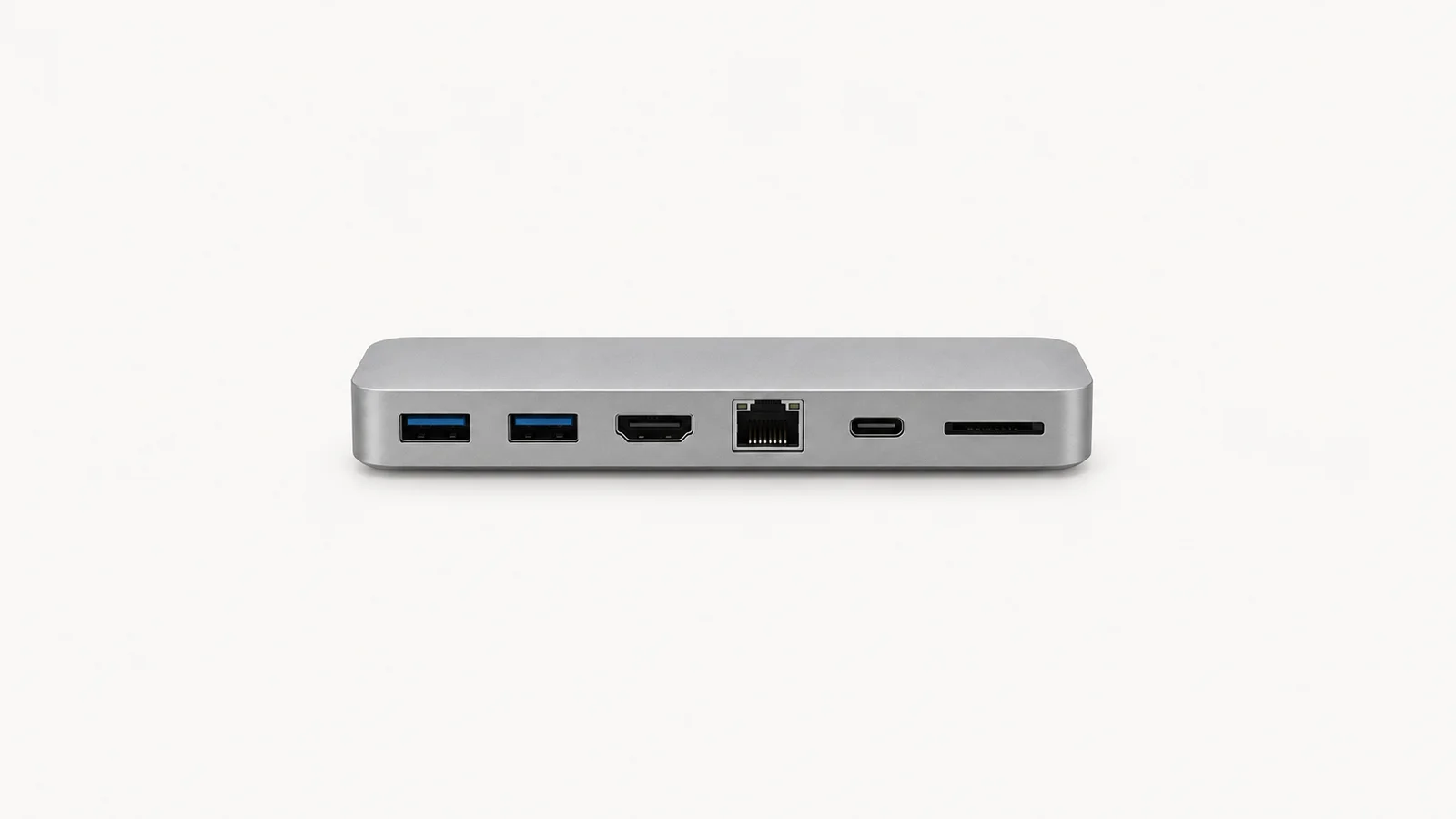 Isolated a USB hub of matte aluminium with six ports centred on a seamless pale off-white studio background, generous empty margin on every side for overlaid branding