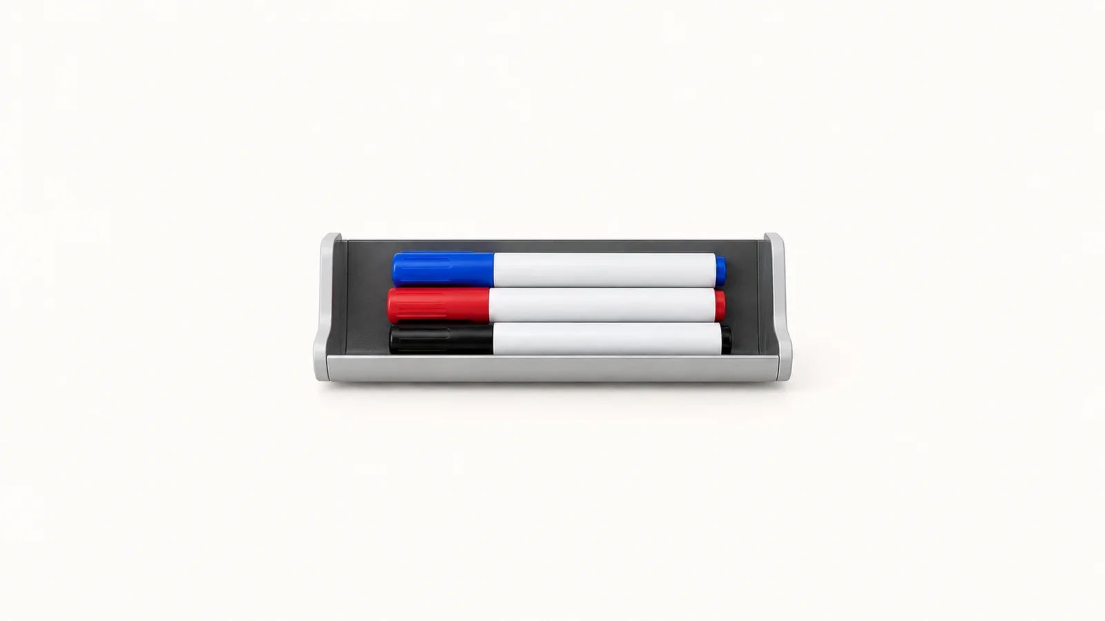 Isolated a magnetic whiteboard pen tray with three markers centred on a seamless pale off-white studio background, generous empty margin on every side for overlaid branding